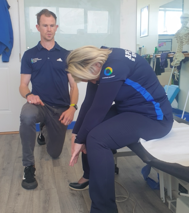 Physio client doing slouching exercise in treatment room