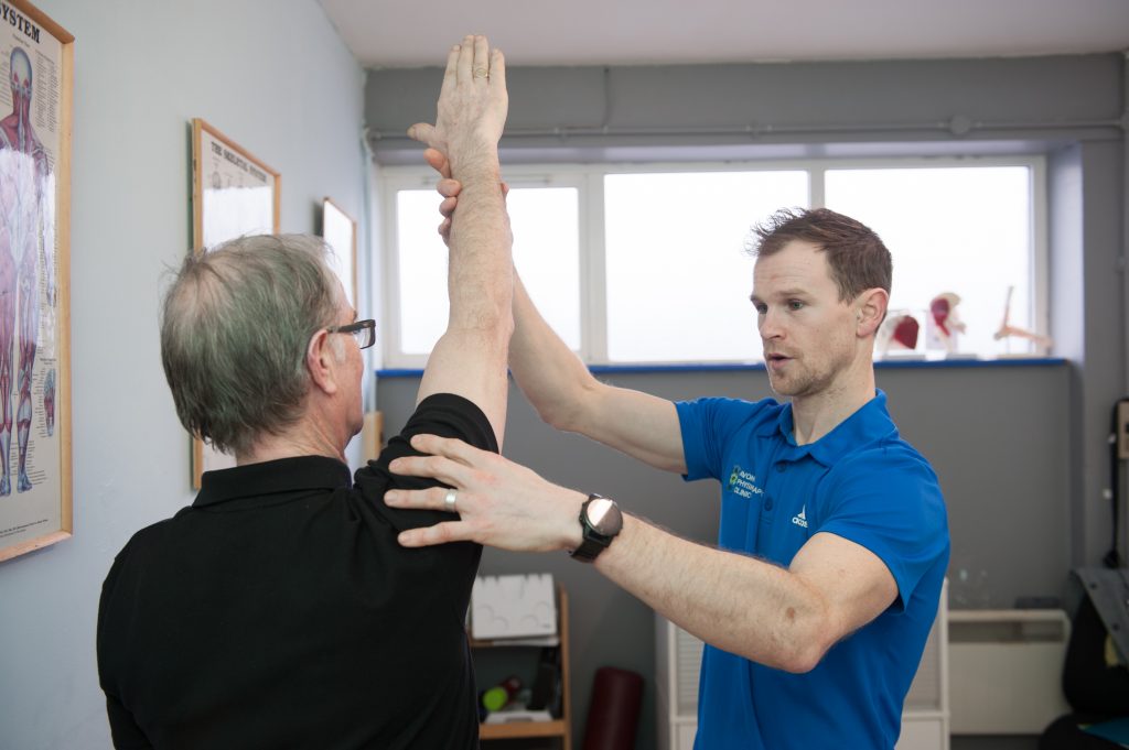 Physio treating a patient with shoulder/ arm problems